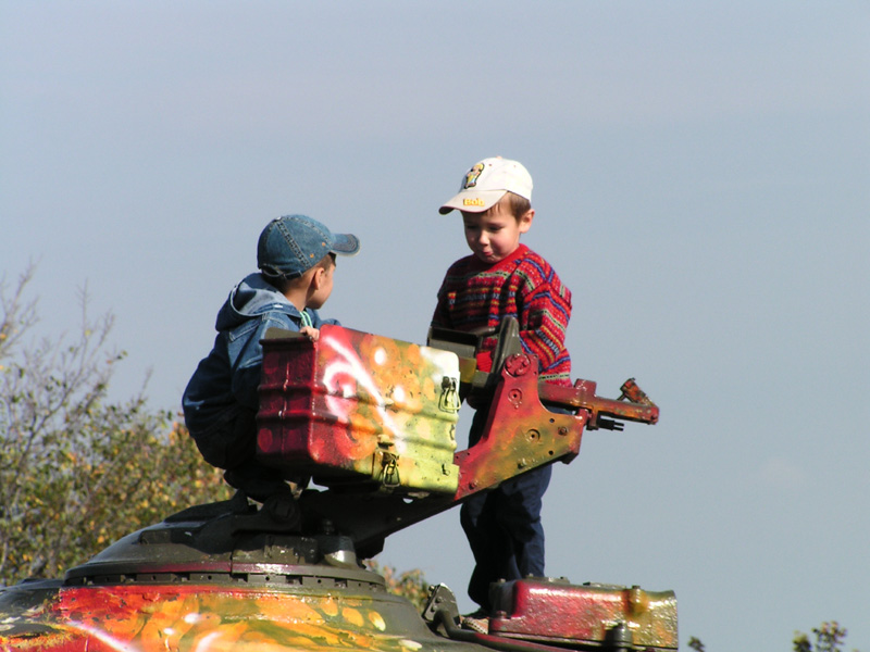 Boys playing with an army tank in Kiev