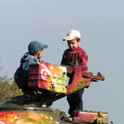 Boys playing with an army tank in Kiev