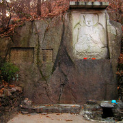 Buddha on a wall and a spring