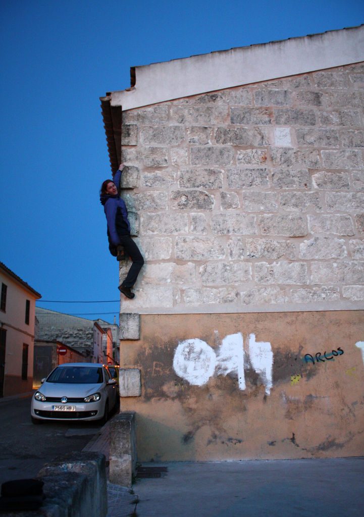 Mallorca - Lukas climbing the wall of an old house in Santa Margalida